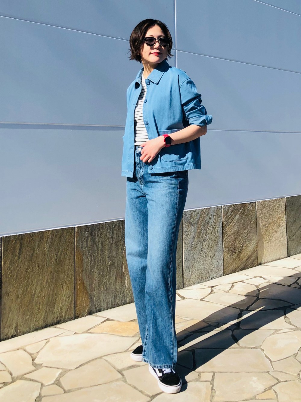 Woman in a light blue denim jacket and matching jeans, winter street style